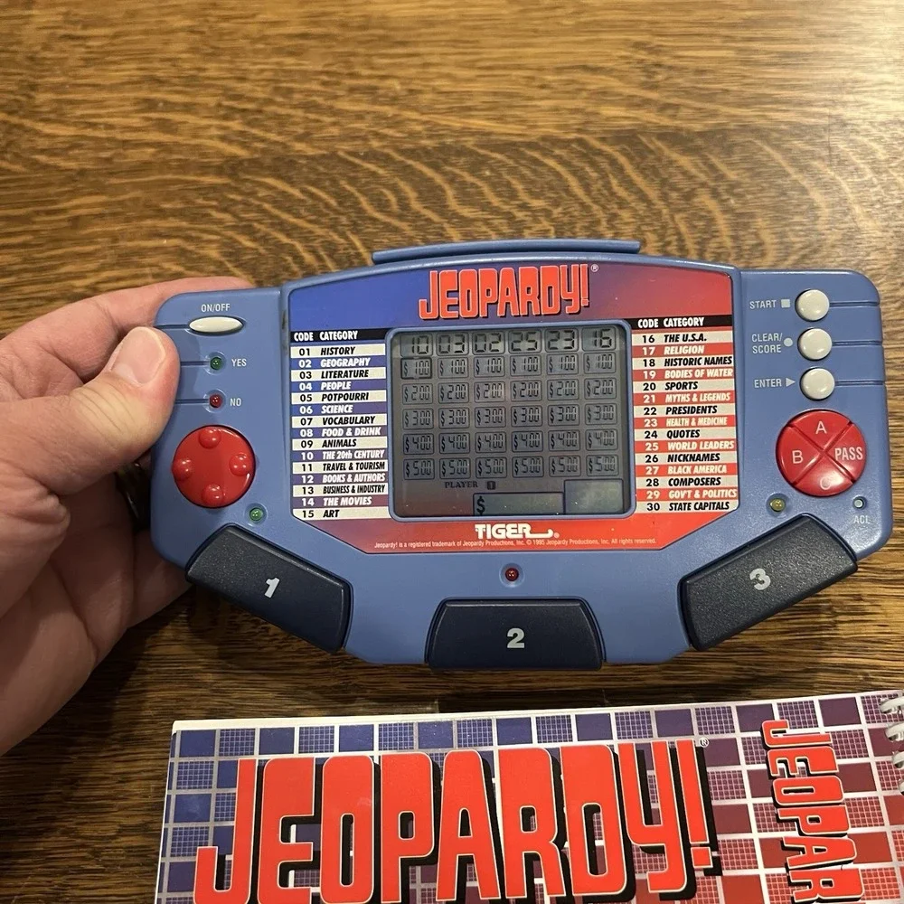 Tiger Electronics Jeopardy Hand Held Game With Cartridge & Answer Question Book